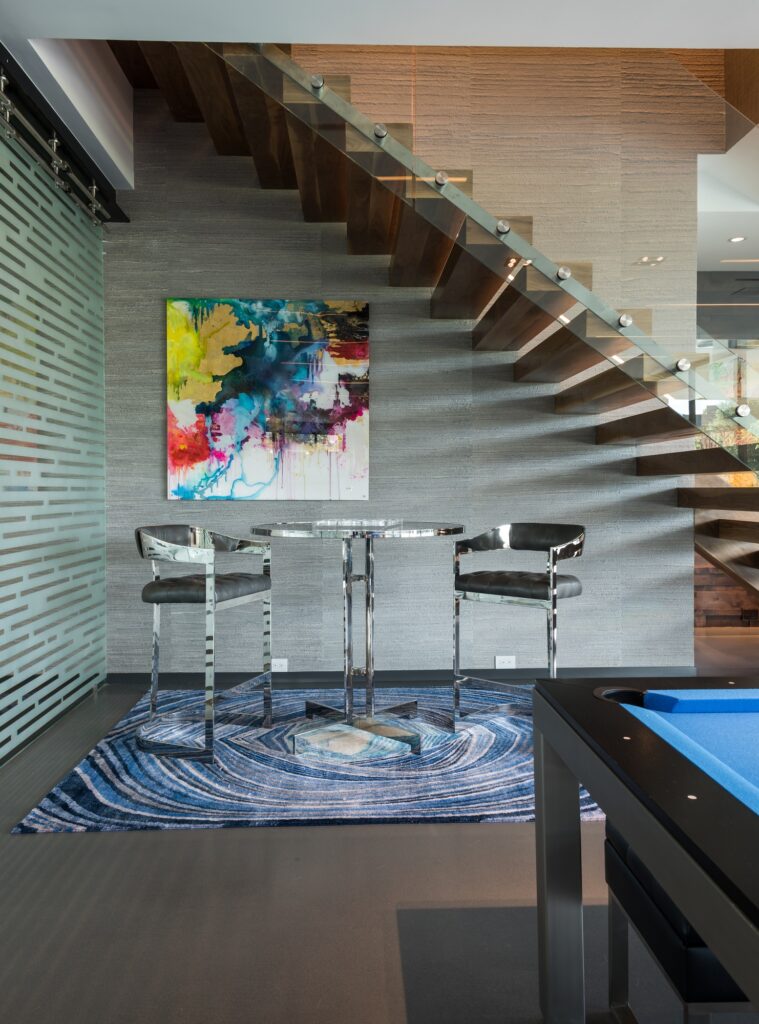 Billiards room with glass staircase