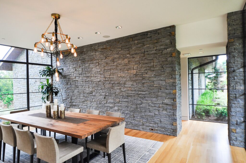 Dining room with large windows and stone accents