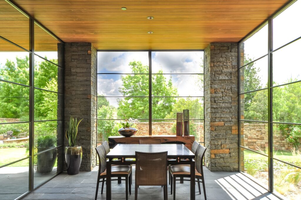 Dining room with floor to ceiling windows on three sides