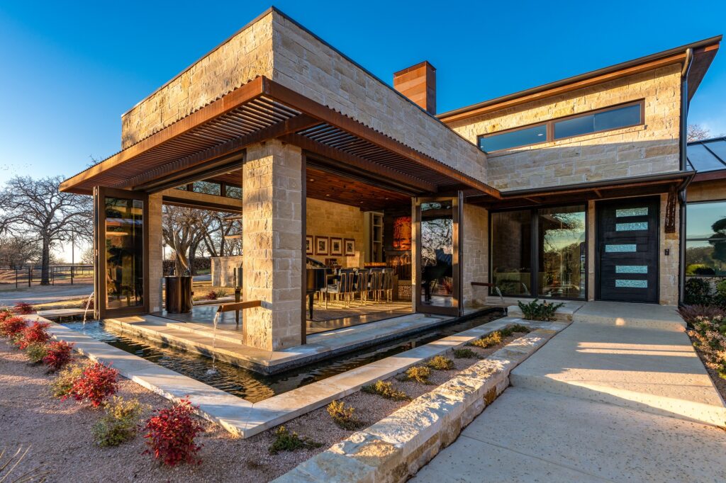 Modern home with landscaped front walk and fountain